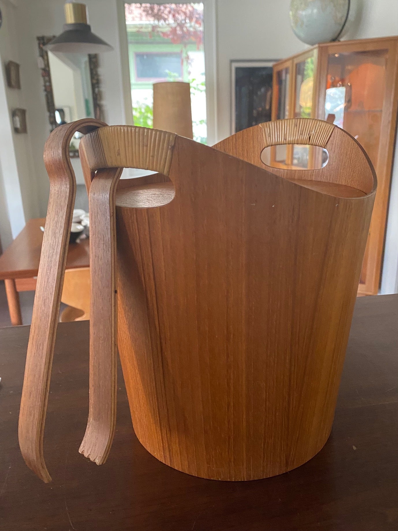 Mid-century teak ice bucket with cane handles. Original aluminum insert in great condition. Comes with matching molded teak tongs- Cook Street Vintage