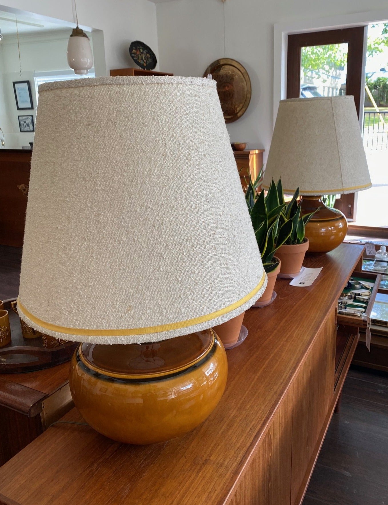 Large ceramic MCM brown table lamps on teak credenza with plants- Cook Street Vintage