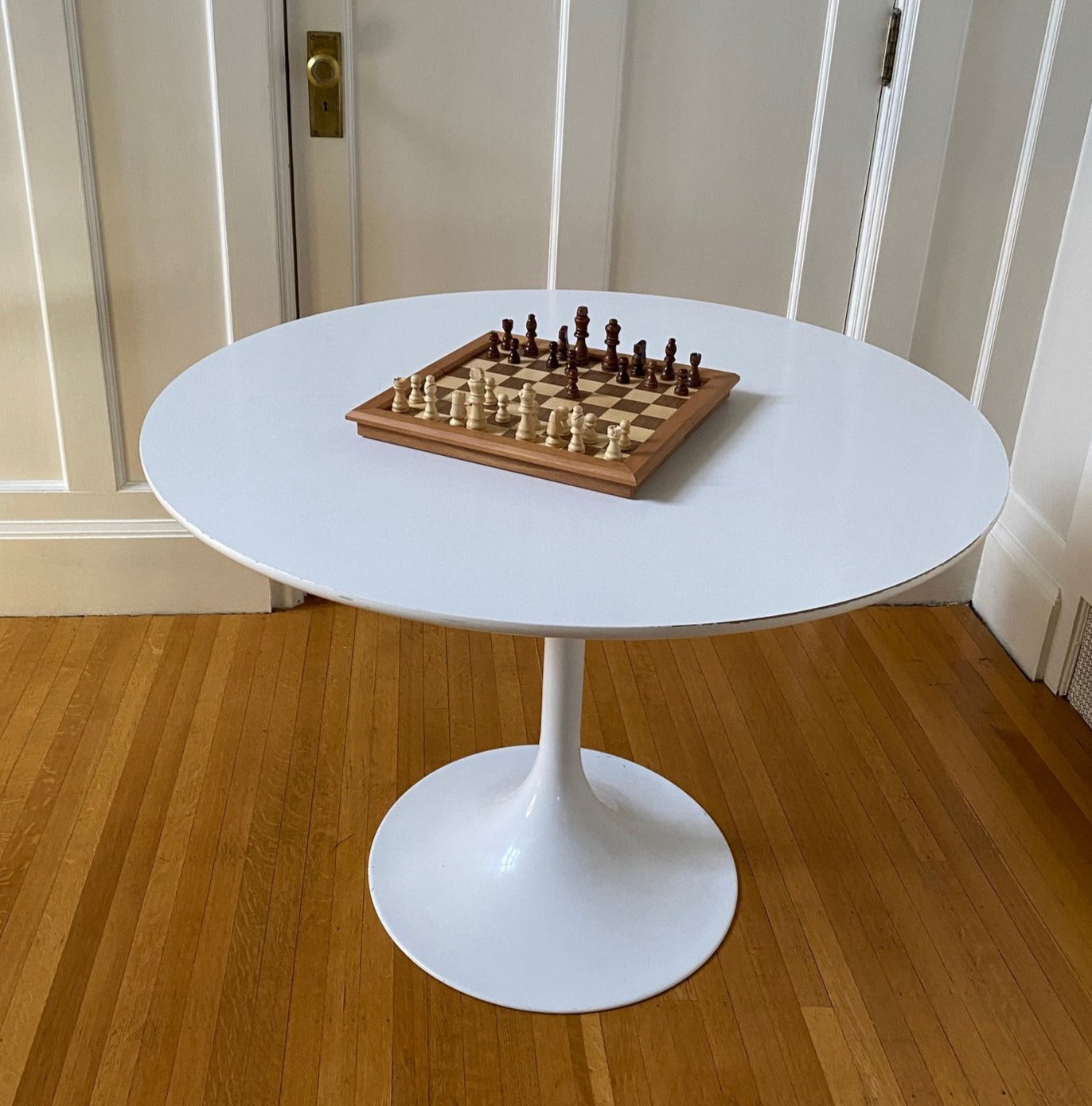 Vintage Tulip Style table. White coated laminate circular top with a finished steel pedestal stem. 